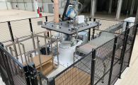 Pentaline EvoDPal Omnis robotic depalletizing unit equipped with a vacuum blanket handling glass containers on an industrial production line.