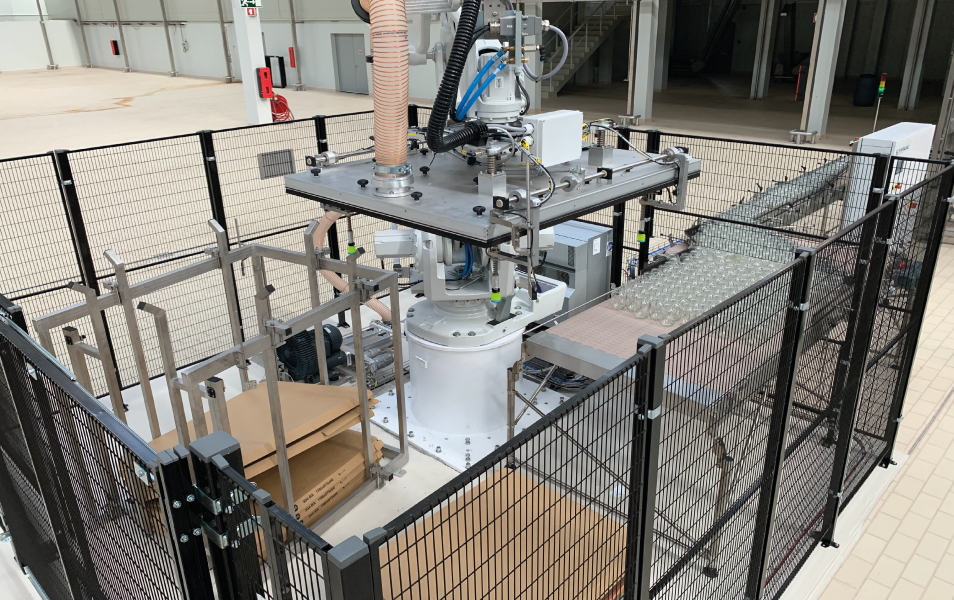 Pentaline EvoDPal Omnis robotic depalletizing unit equipped with a vacuum blanket handling glass containers on an industrial production line.